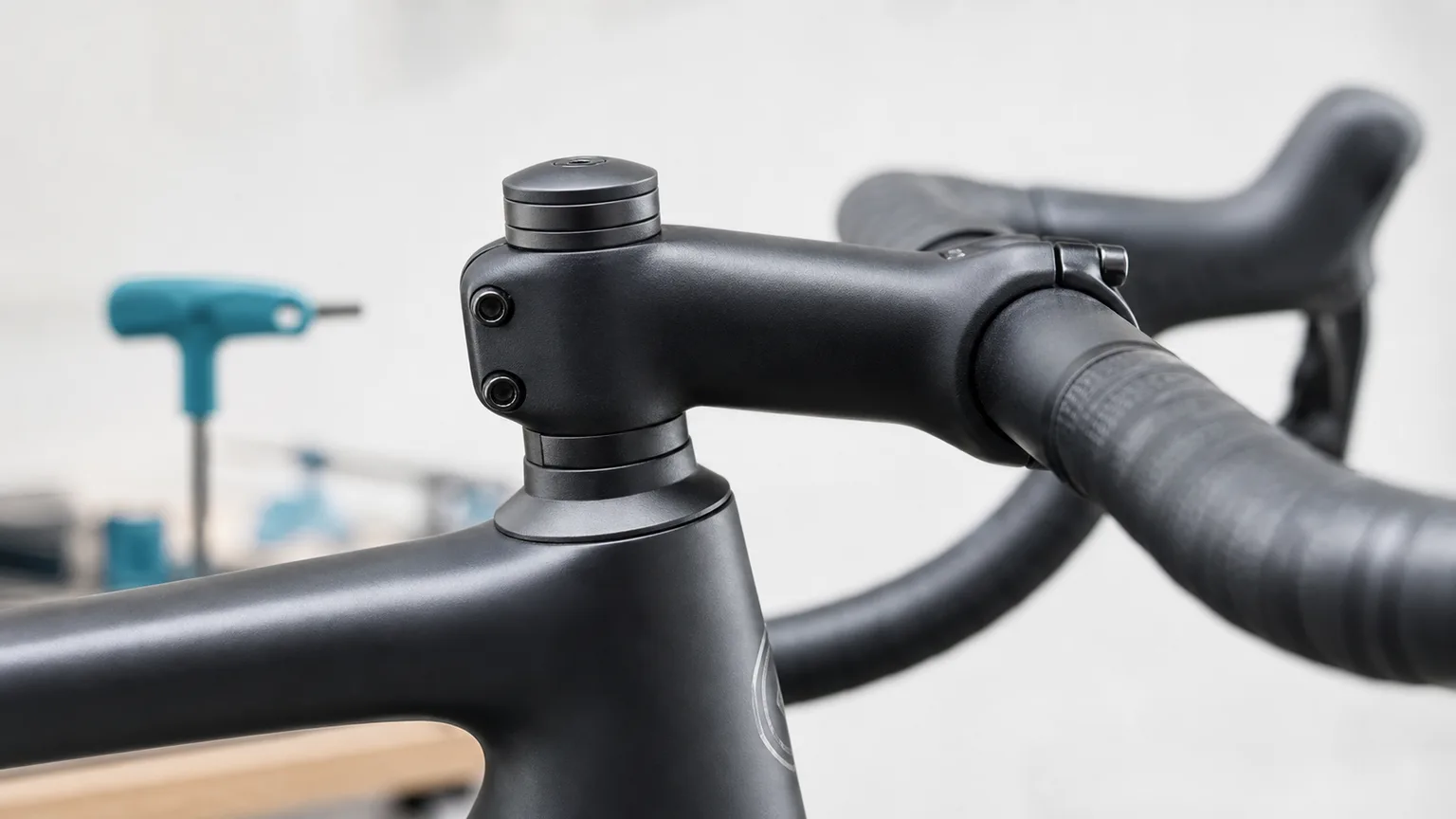 Close-up of a finished matte black road-bike stem and its short, physically visible spacer stack.